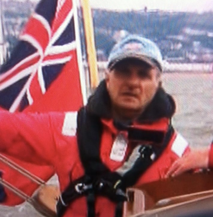 David White in the cockpit of a cruising yacht