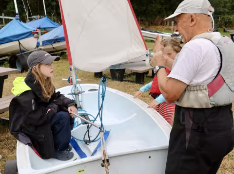 Youngsters can be taught sailing techniques on-land. Instruction in an Oppie on-land